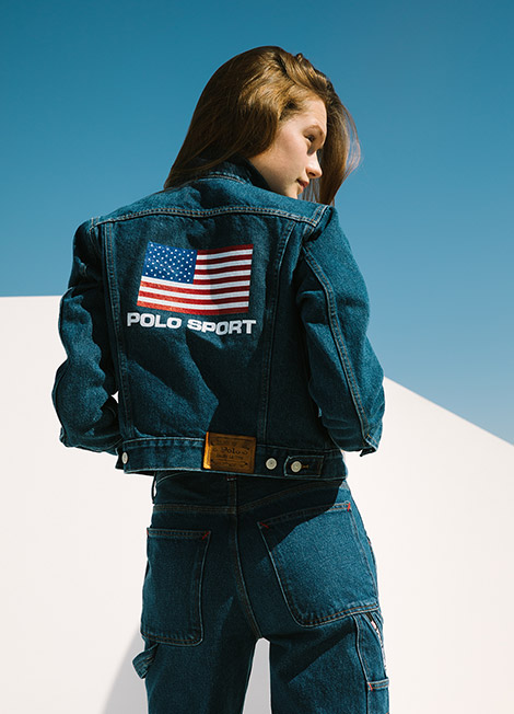 Woman in Polo Sport denim jacket with American flag motif at back