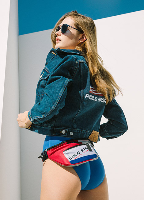 Woman in Polo Sport denim jacket and wearing Polo Sport waist pack