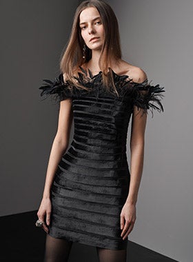 Woman in feather-trimmed paneled minidress
