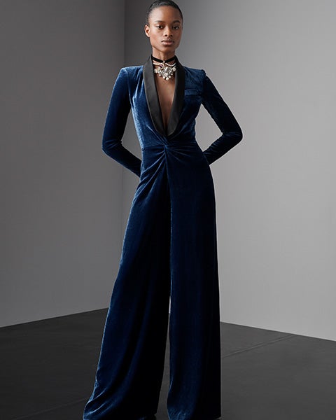 Woman in blue velvet jumpsuit